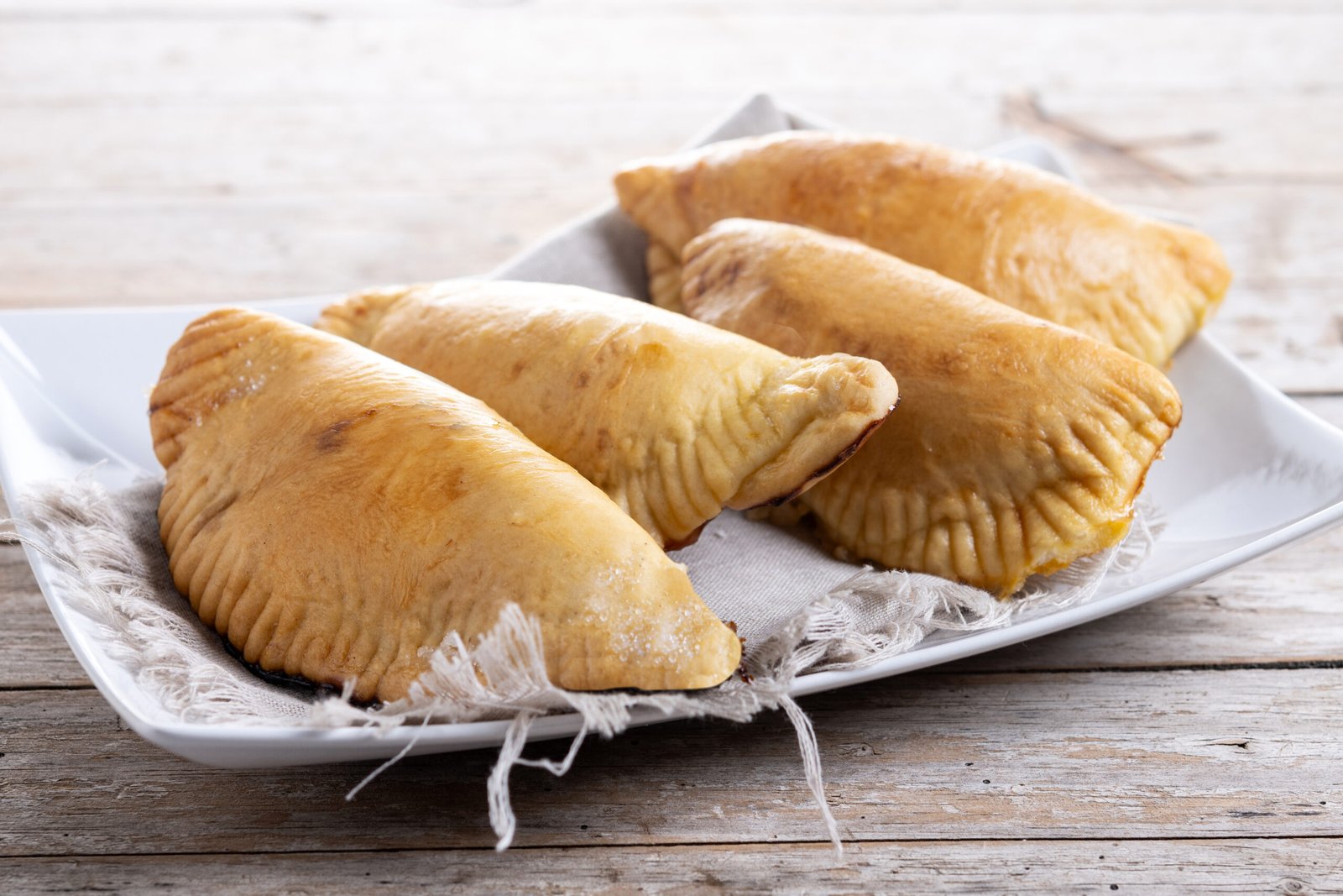 pumpkin empanadillas for halloween or thanksgiving's day on wood